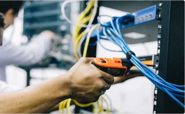 Technician installing networking equipment